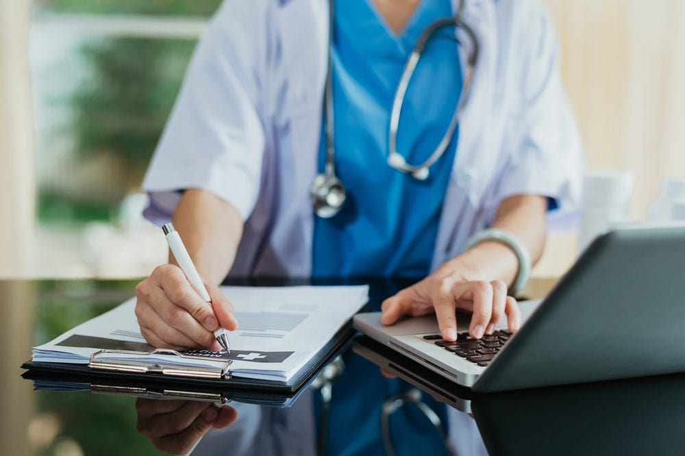 Medical Technology Concept. Doctor Working With Mobile Phone And Stethoscope